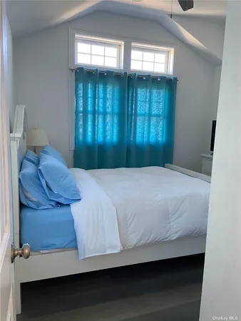 a bedroom with a bed and window