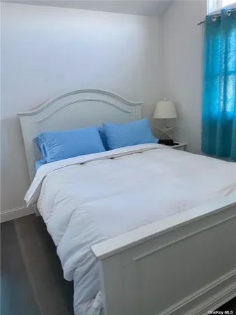 a bedroom with a bed and night stand