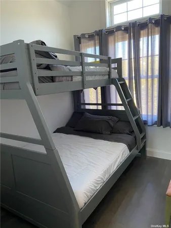 a bed sitting in a room next to a window