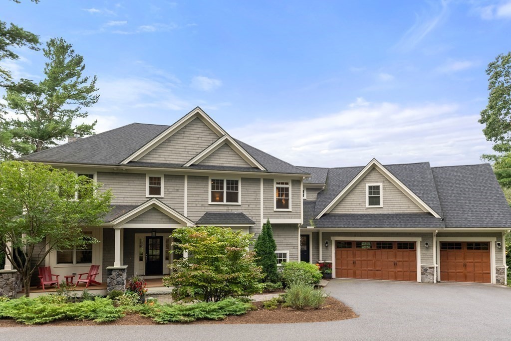 a front view of a house with yard and green space