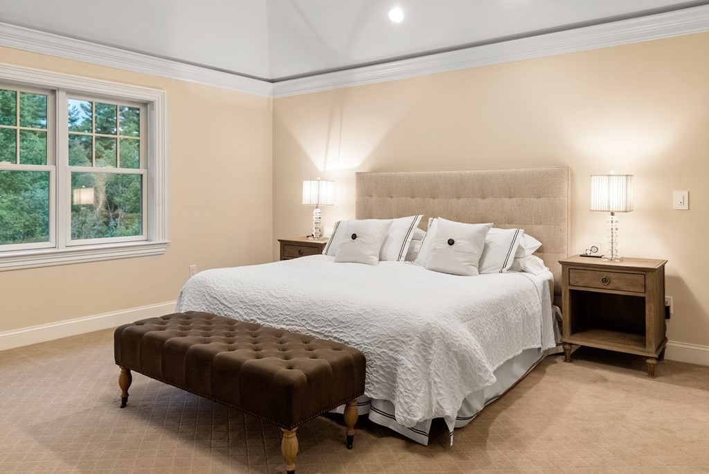 4 Fields Lane Wayland, MA 01778 - Photo 18 of 39 a bedroom with a bed and a fireplace