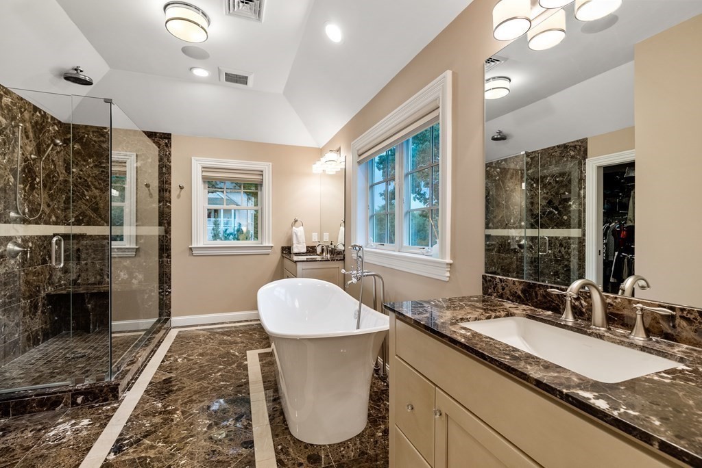 4 Fields Lane Wayland, MA 01778 - Photo 20 of 39 a bathroom with a granite countertop sink a toilet and a large mirror