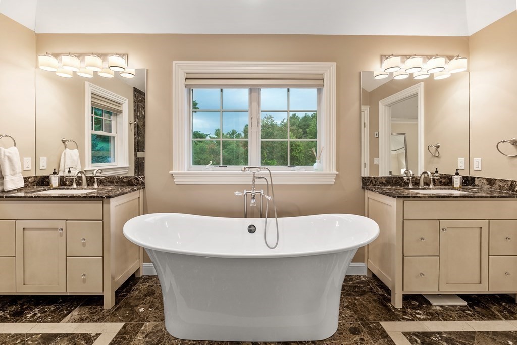 4 Fields Lane Wayland, MA 01778 - Photo 21 of 39 a white bath tub sitting next to a bathroom sink