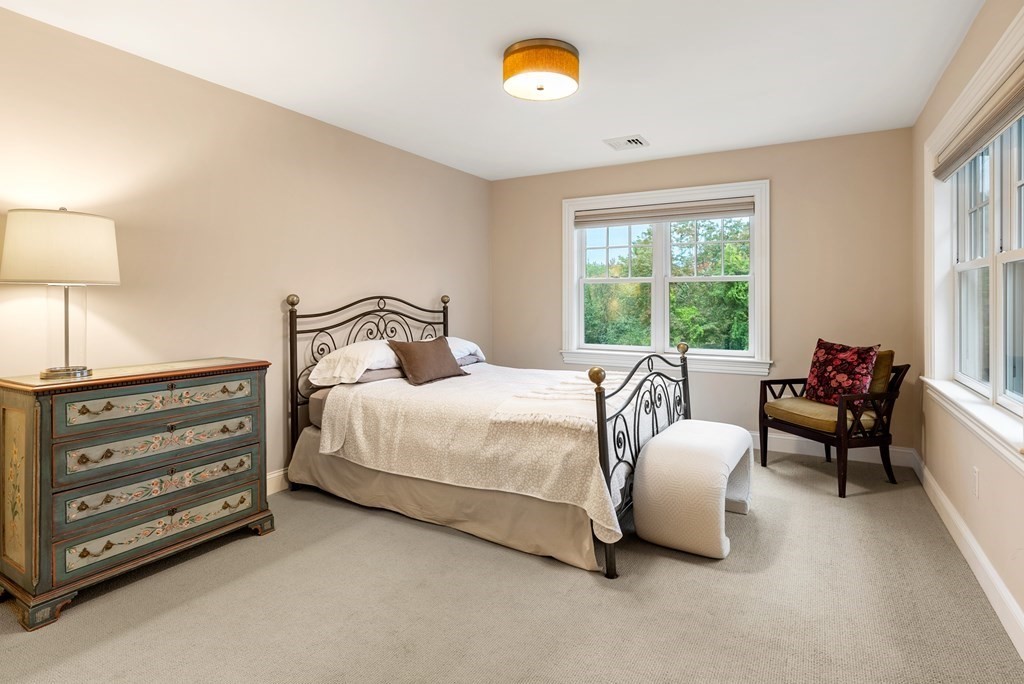 4 Fields Lane Wayland, MA 01778 - Photo 23 of 39 a bedroom with a bed and a chandelier