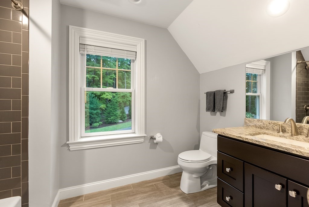 4 Fields Lane Wayland, MA 01778 - Photo 27 of 39 a bathroom with a toilet a sink and a mirror