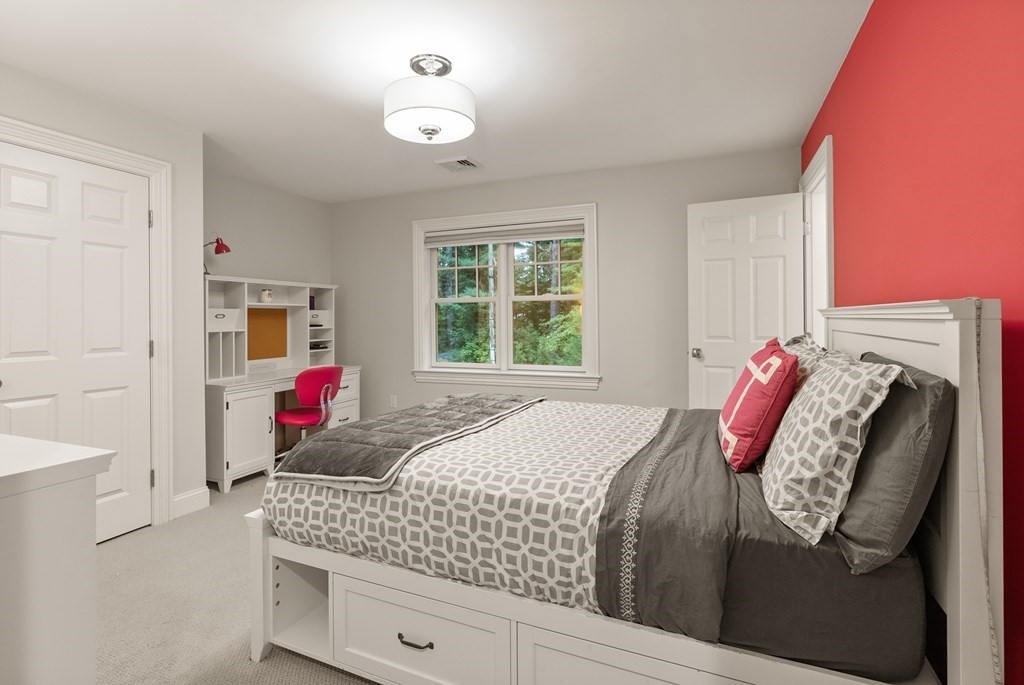 4 Fields Lane Wayland, MA 01778 - Photo 28 of 39 a bed room with a bed and a couch