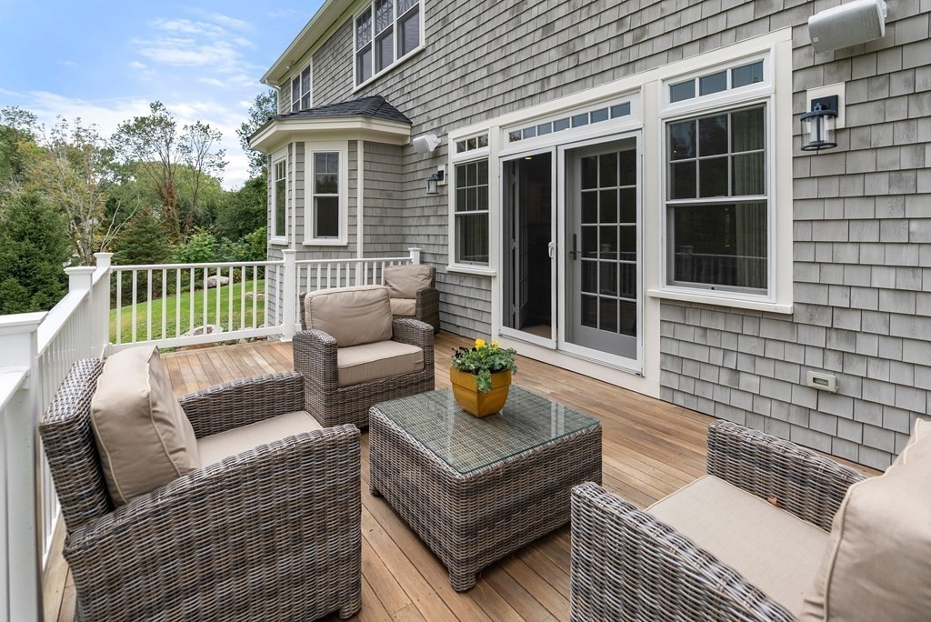 4 Fields Lane Wayland, MA 01778 - Photo 35 of 39 a view of a patio with couches chairs and wooden floor