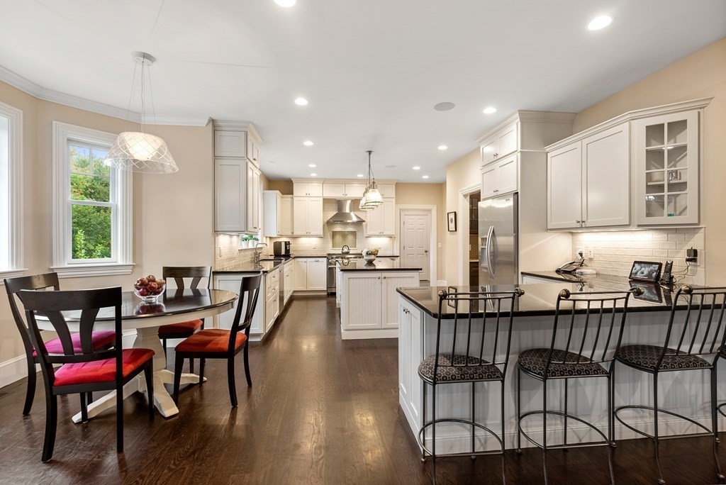 4 Fields Lane Wayland, MA 01778 - Photo 9 of 39 a view of a dining room with furniture and wooden floor