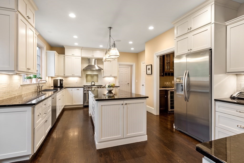 4 Fields Lane Wayland, MA 01778 - Photo 10 of 39 a large kitchen with stainless steel appliances kitchen island granite countertop a large counter top stainless steel appliances and cabinets