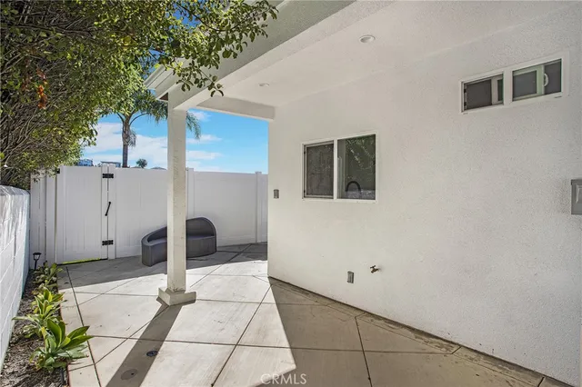 a backyard of a house with table and chair