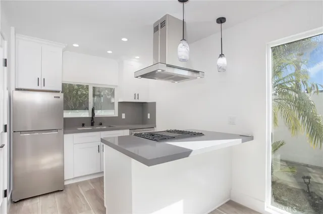 a kitchen with a sink a refrigerator and a stove