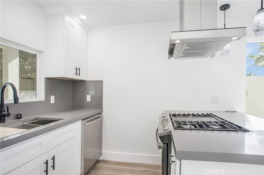 24216 Las Naranjas Drive, Unit B Laguna Niguel, CA 92677 - Photo 5 of 15 a kitchen with stainless steel appliances granite countertop a sink stove and cabinets