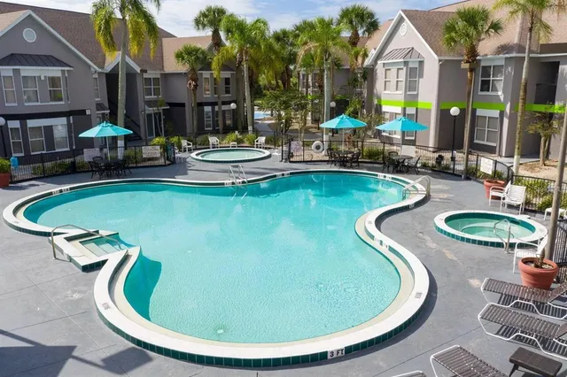 a view of a swimming pool with lounge chairs