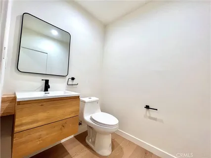 a bathroom with a toilet a sink and mirror