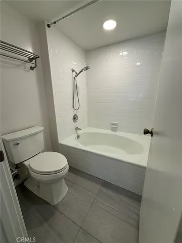 a bathroom with a toilet and a bathtub