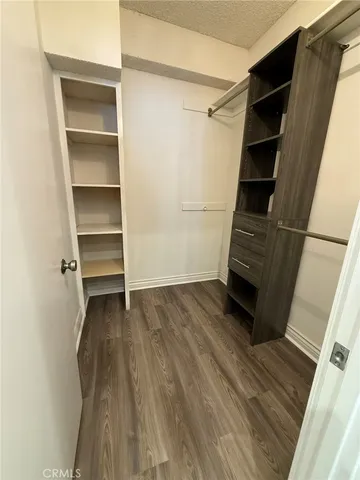 a view of walk in closet with empty racks