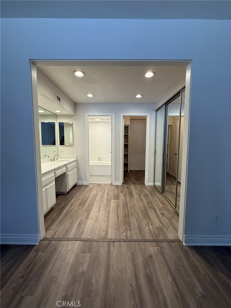 5555 Canyon Crest Drive, Unit 3B Riverside, CA 92507 - Photo 16 of 26 a view of a hallway with wooden floor and a living room
