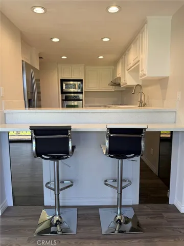 a kitchen with a sink cabinets and appliances