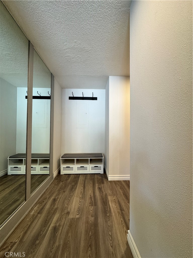 5555 Canyon Crest Drive, Unit 3B Riverside, CA 92507 - Photo 21 of 26 a view of a room with wooden floor and furniture