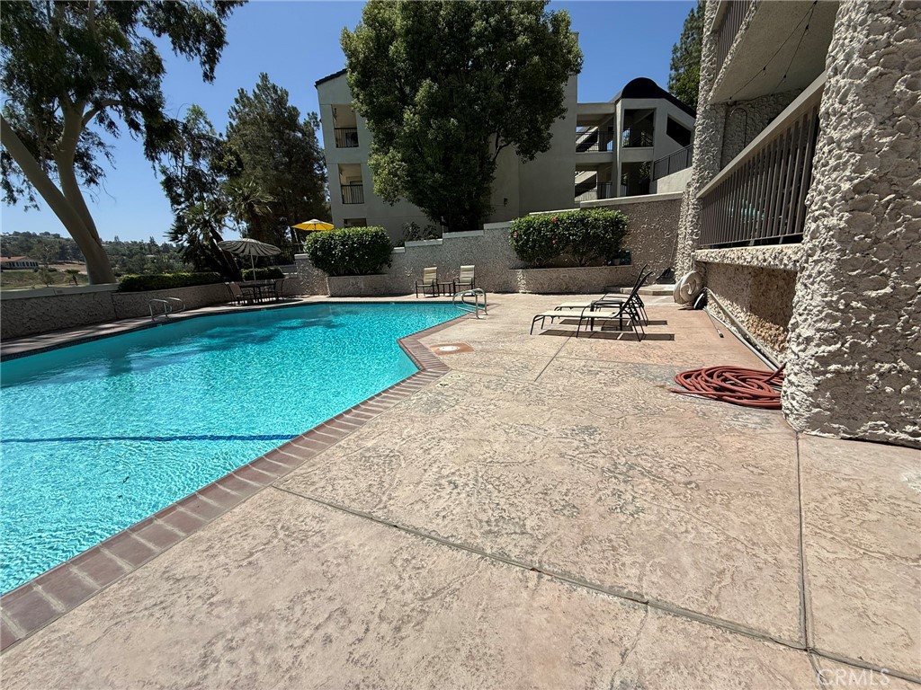 5555 Canyon Crest Drive, Unit 3B Riverside, CA 92507 - Photo 24 of 26 a view of a backyard with sitting area