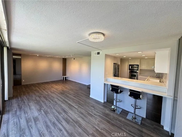 a view of living room with furniture and wooden floor