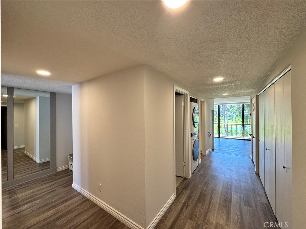 5555 Canyon Crest Drive, Unit 3B Riverside, CA 92507 - Photo 5 of 26 a view of a hallway with wooden floor and closet