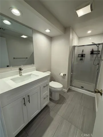a bathroom with a double vanity sink toilet and shower
