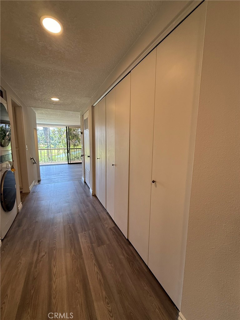 5555 Canyon Crest Drive, Unit 3B Riverside, CA 92507 - Photo 9 of 26 a view of a hallway with wooden floor and a sink
