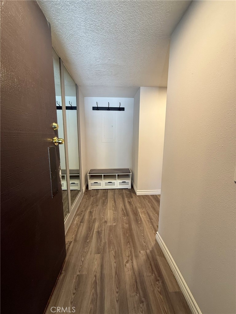 5555 Canyon Crest Drive, Unit 3B Riverside, CA 92507 - Photo 10 of 26 a view of a room with wooden floor and staircase