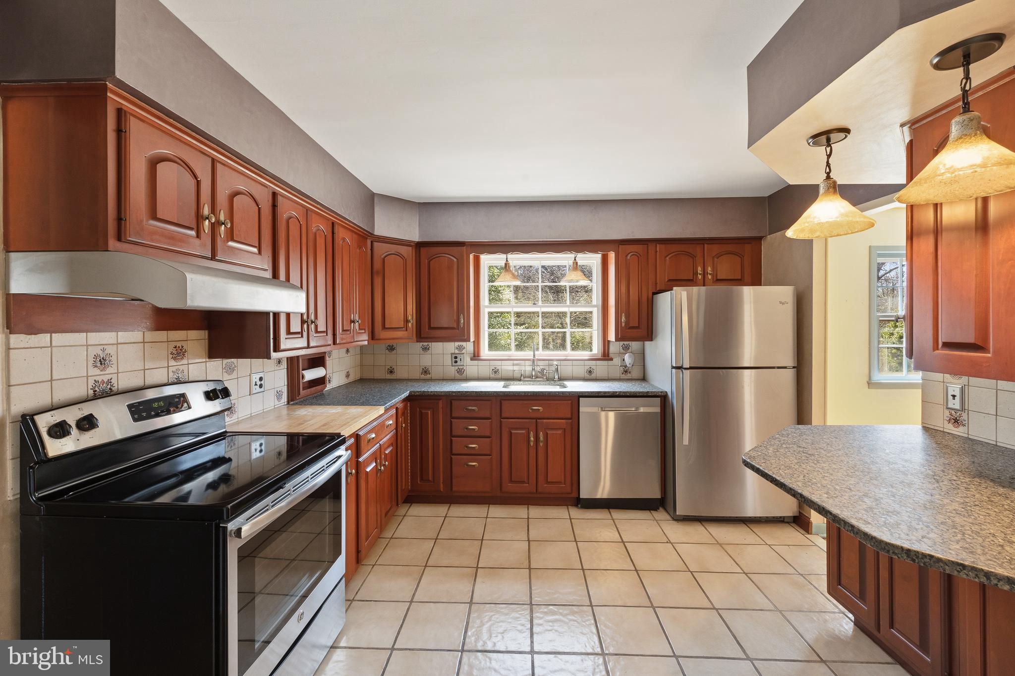 413 Columbia Avenue Pitman, NJ 08071 - Photo 12 of 33 a kitchen with a stove a refrigerator and a sink