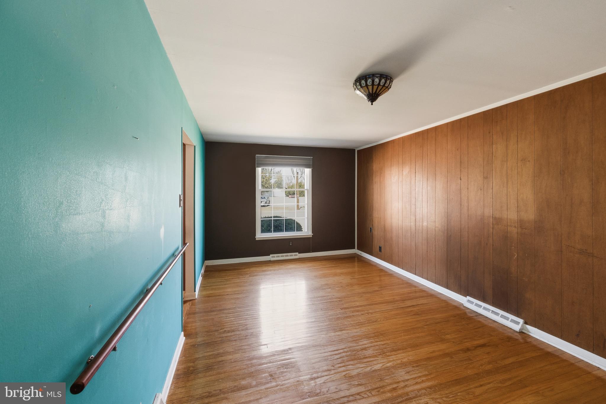 413 Columbia Avenue Pitman, NJ 08071 - Photo 15 of 33 a view of an empty room with window and wooden floor