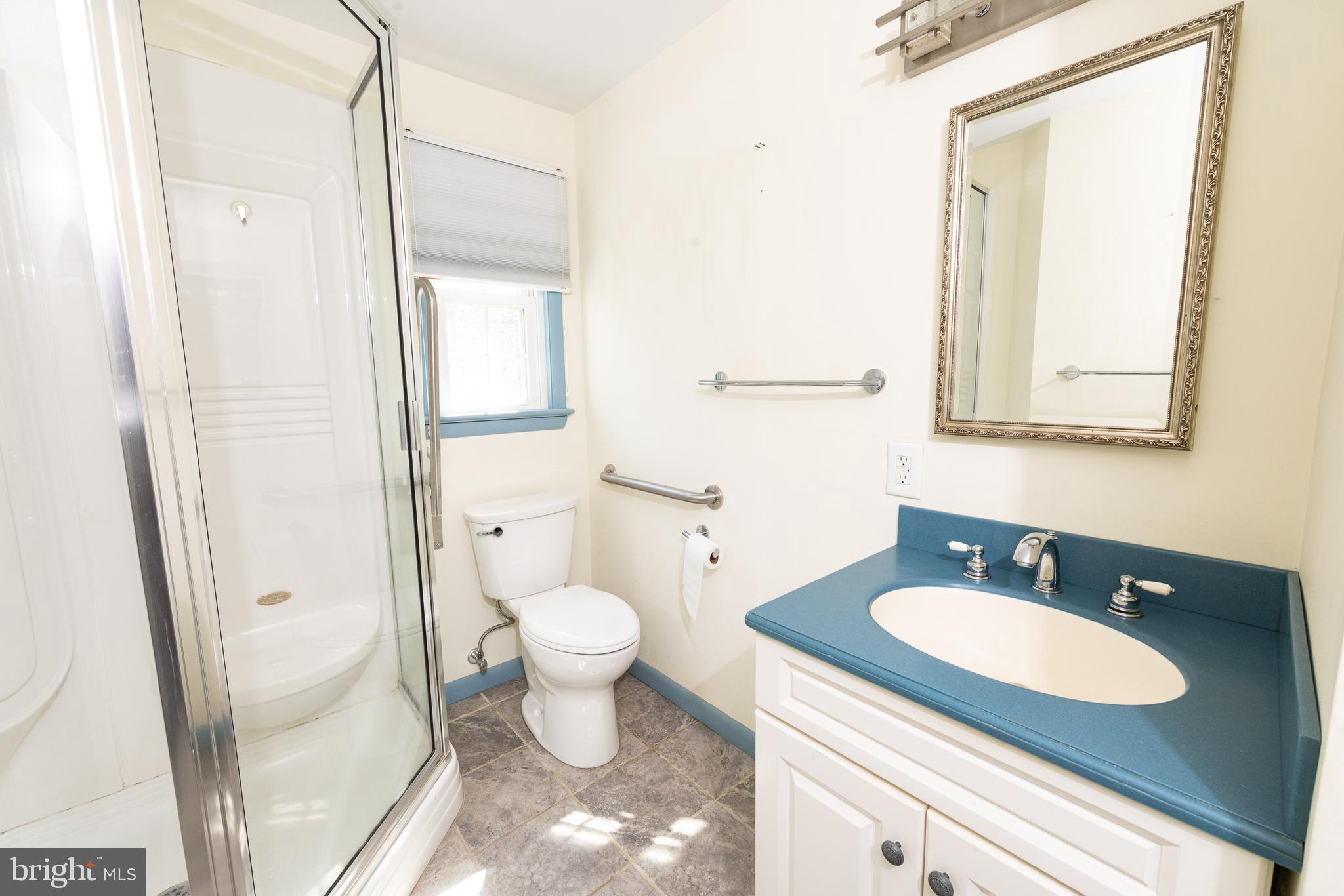 413 Columbia Avenue Pitman, NJ 08071 - Photo 23 of 33 a bathroom with a granite countertop sink toilet a mirror and a shower