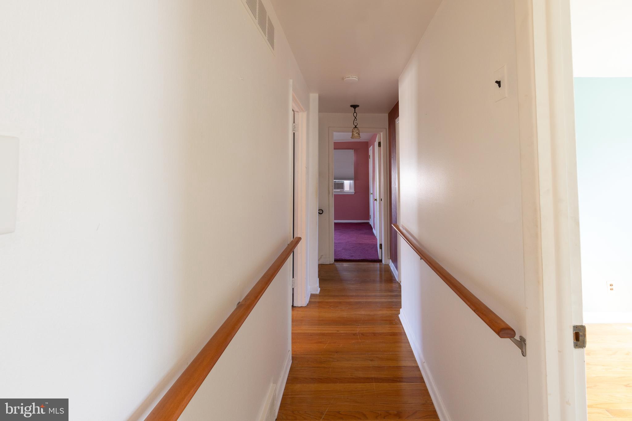413 Columbia Avenue Pitman, NJ 08071 - Photo 29 of 33 a view of a hallway with the wooden floor