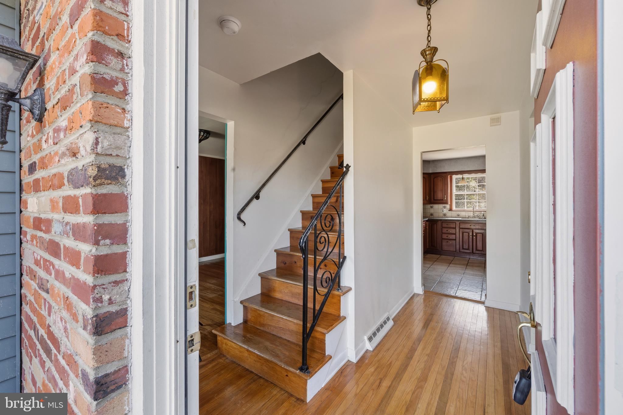 413 Columbia Avenue Pitman, NJ 08071 - Photo 8 of 33 a view of a hallway with wooden floor and staircase