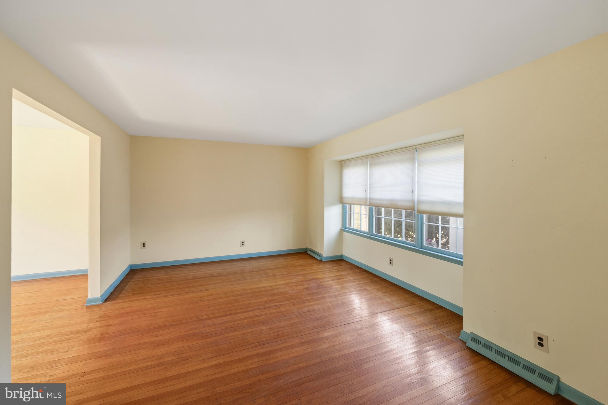 413 Columbia Avenue Pitman, NJ 08071 - Photo 9 of 33 an empty room with wooden floor and windows
