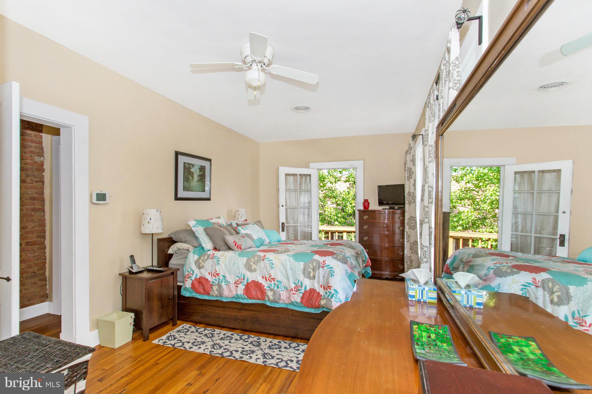 629 Aldershot Road Baltimore, MD 21229 - Photo 22 of 30 a bedroom with a bed and wooden floor