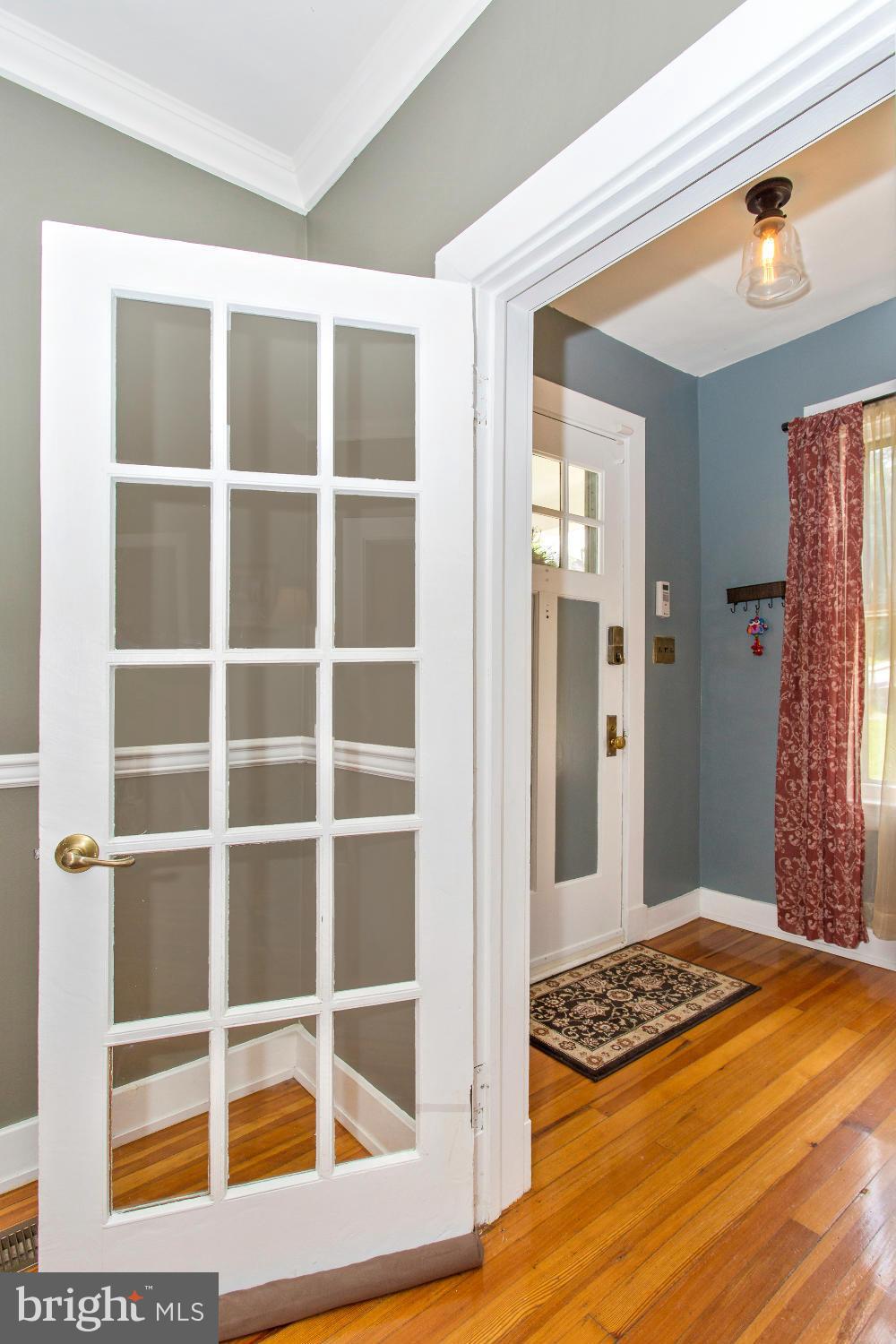 629 Aldershot Road Baltimore, MD 21229 - Photo 8 of 30 a view of an empty room with wooden floor and a window