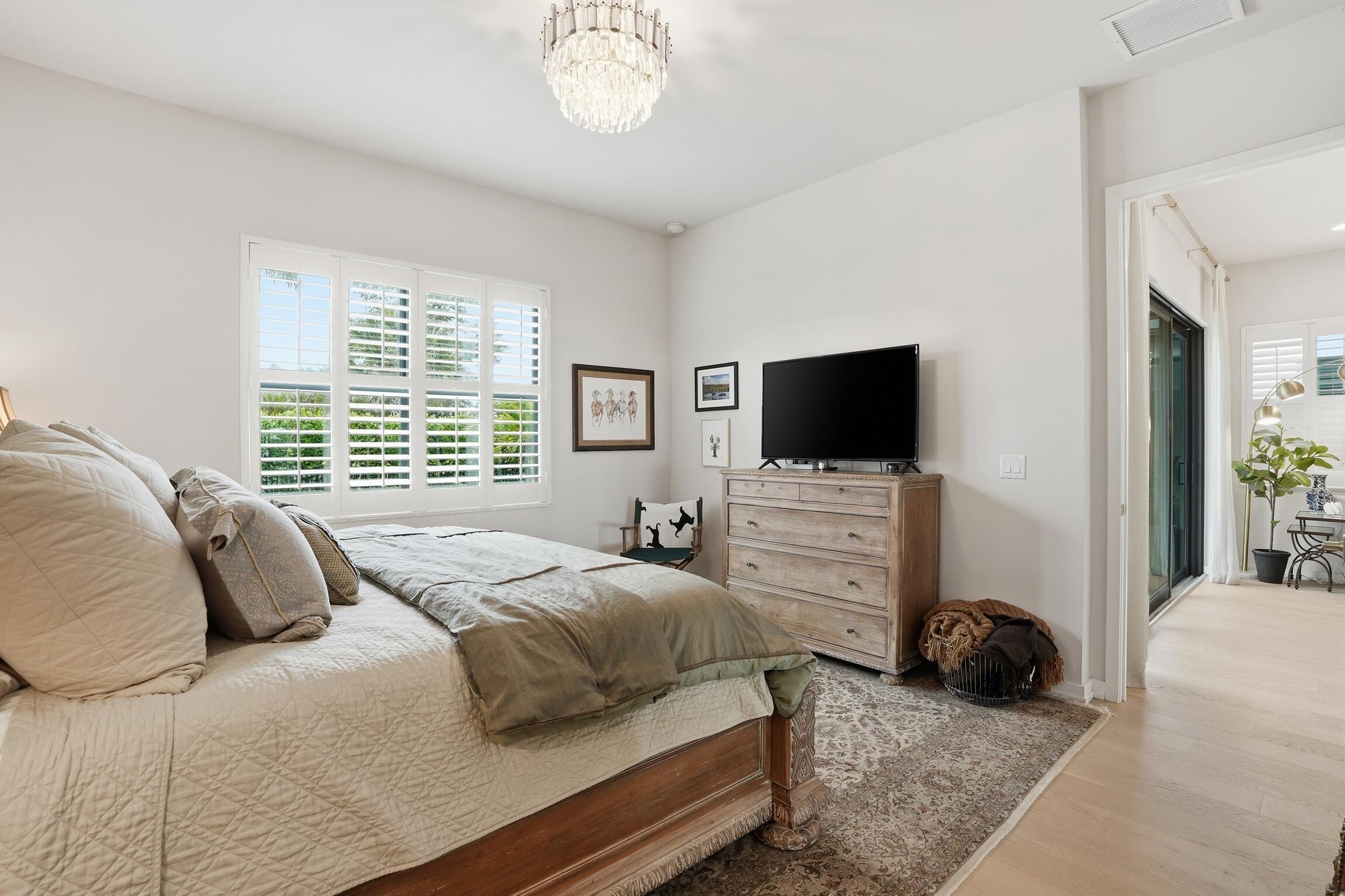 14708 Kingfisher Loop Naples, FL 34120 - Photo 21 of 42 a bedroom with a bed flat screen tv and a window