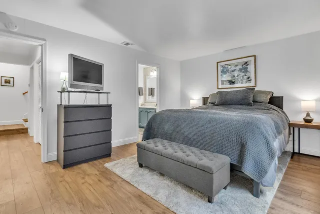 a bedroom with a bed and a television