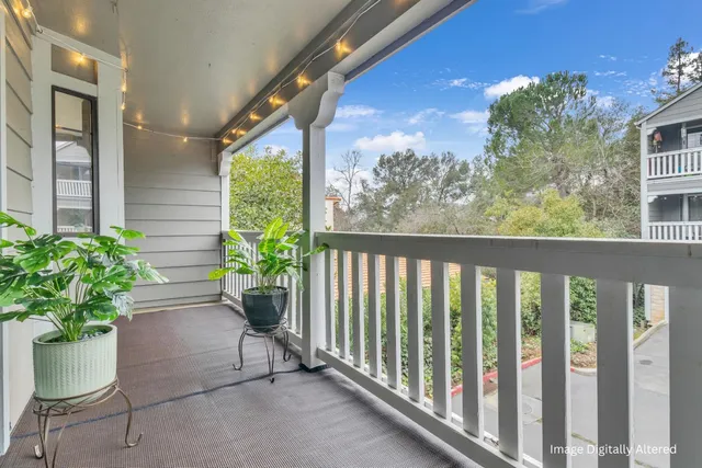 a view of a porch with potted plants