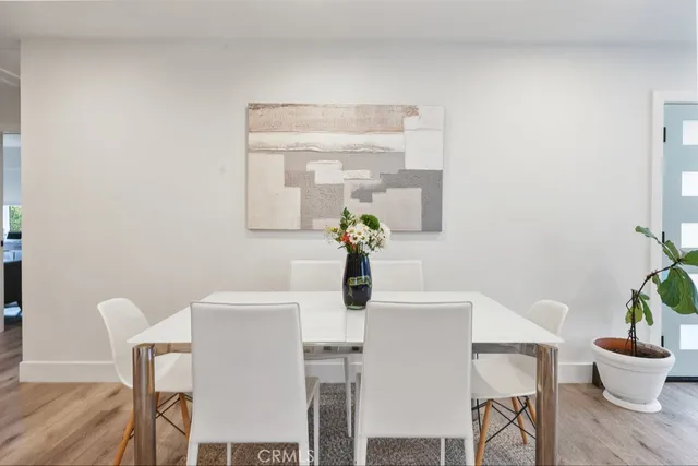 a dining room with furniture and wooden floor
