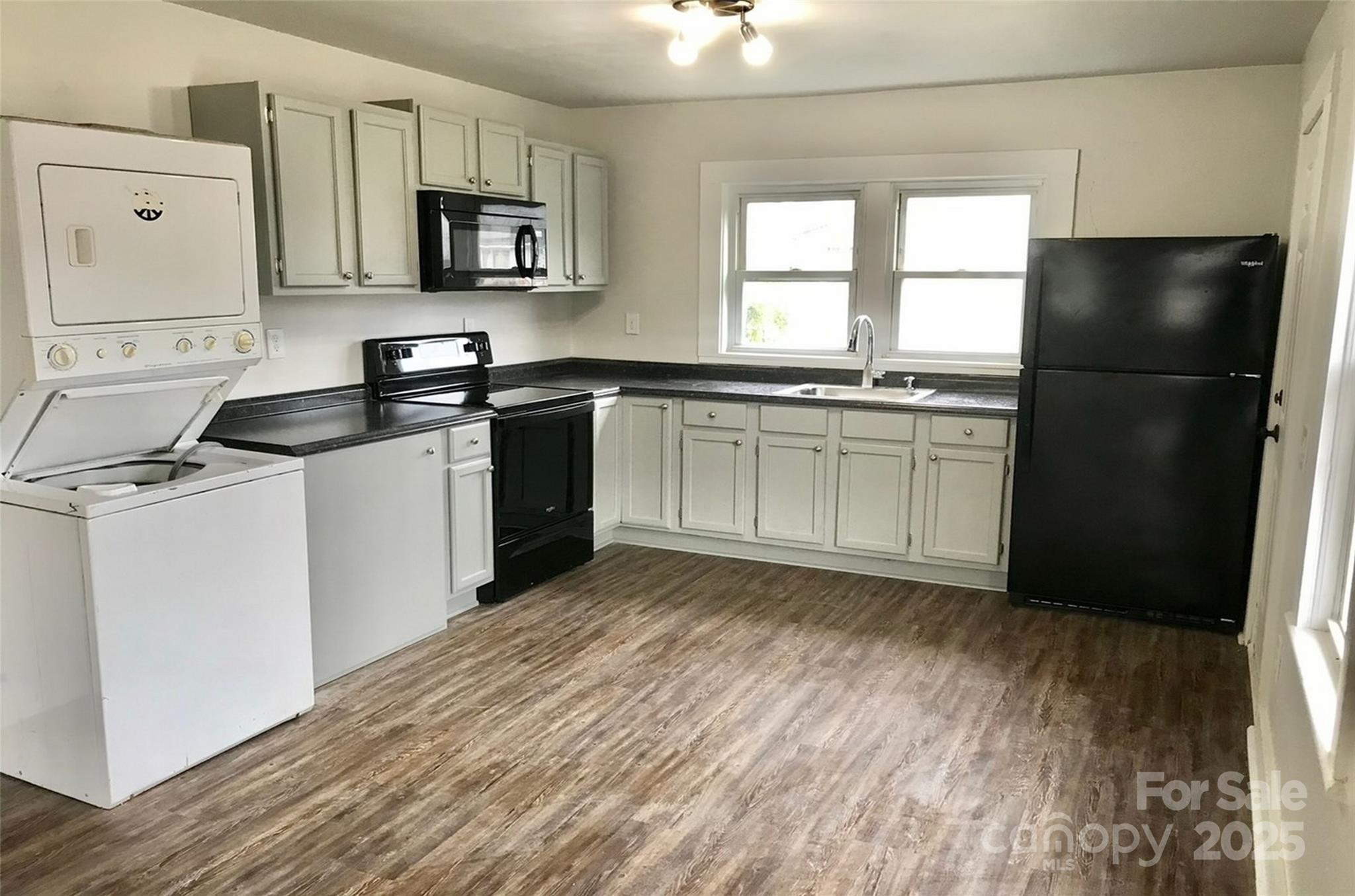 24 Timber Lane Waynesville, NC 28786 - Photo 8 of 13 a kitchen with granite countertop a refrigerator stove top oven and sink