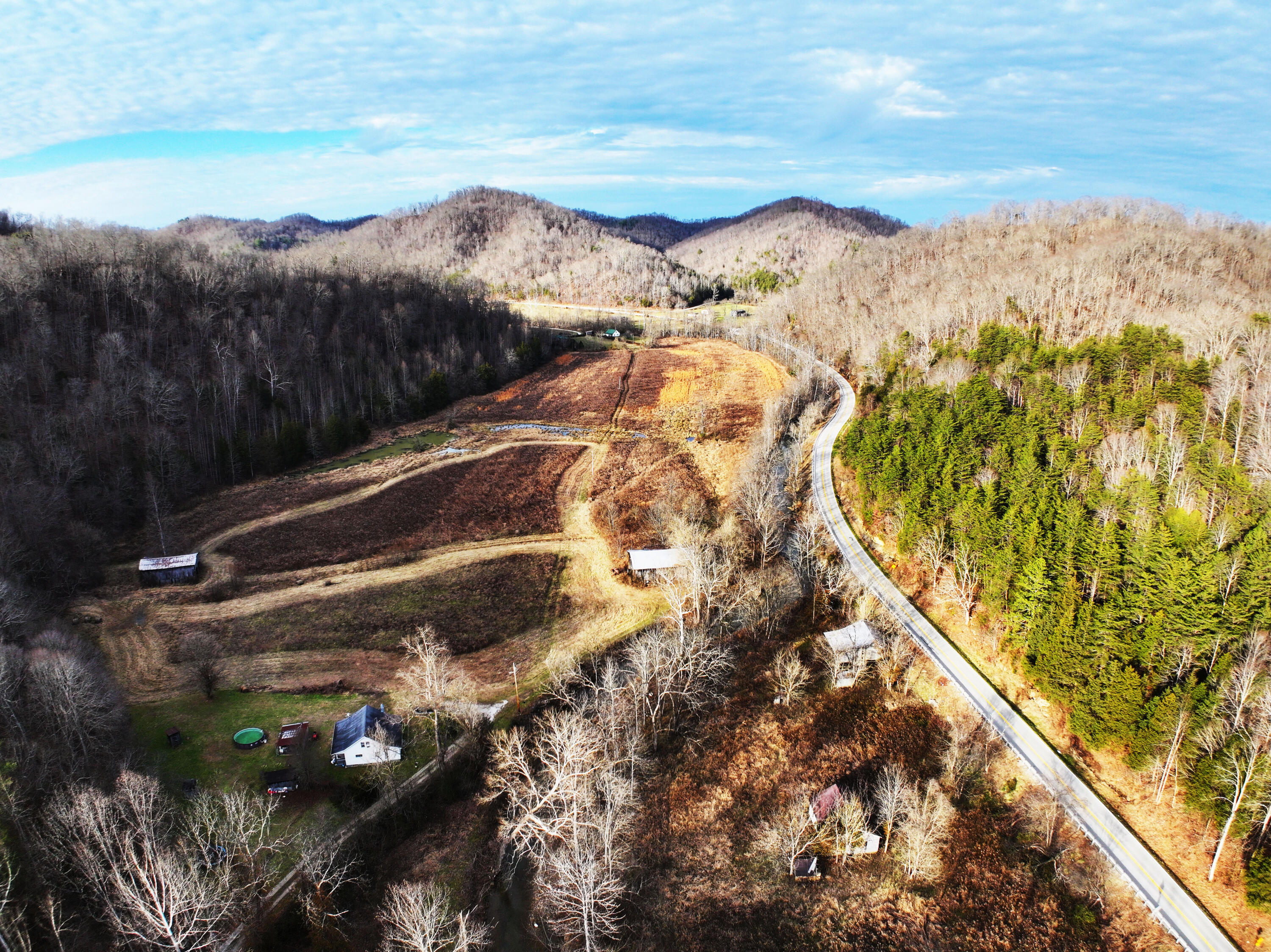 162 acres of Kentucky mountain farmland featuring a home, multiple barns, marketable timber, and homesteader potential — peaceful country living yet conveniently close to town, schools, and outdoor recreation!