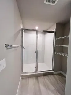 a view of empty room with wooden floor