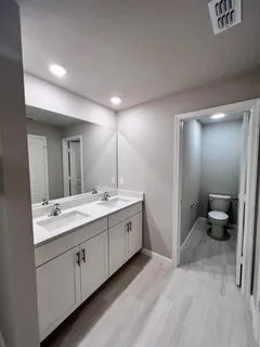 a spacious bathroom with a double vanity sink and a mirror