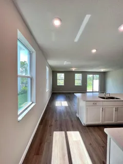 a view of a kitchen with a sink and wooden floor