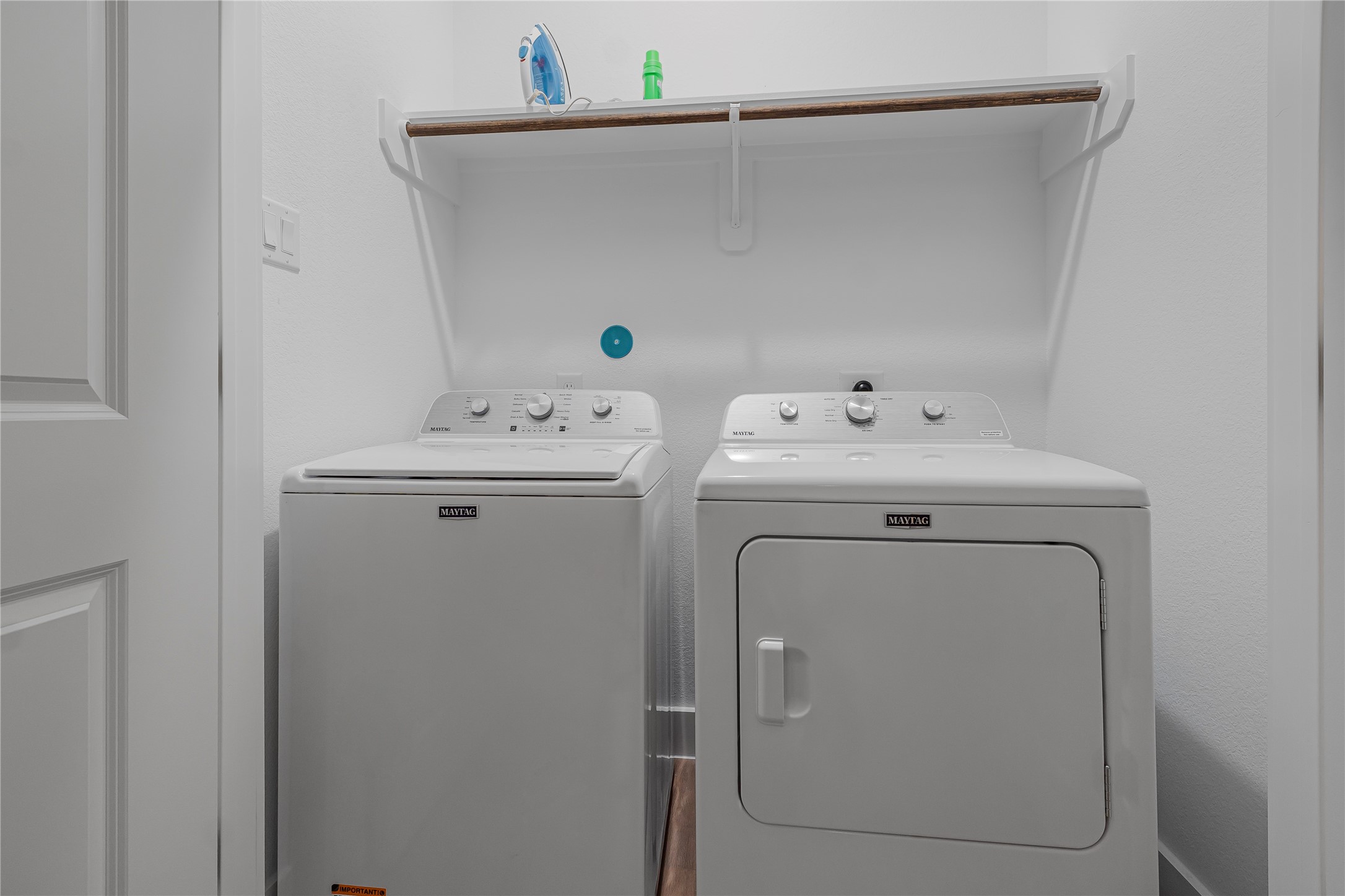 7107 Foster Street, Unit B Houston, TX 77021 - Photo 13 of 18 Convenient laundry space featuring a washer and dryer with an overhead shelf for storage.