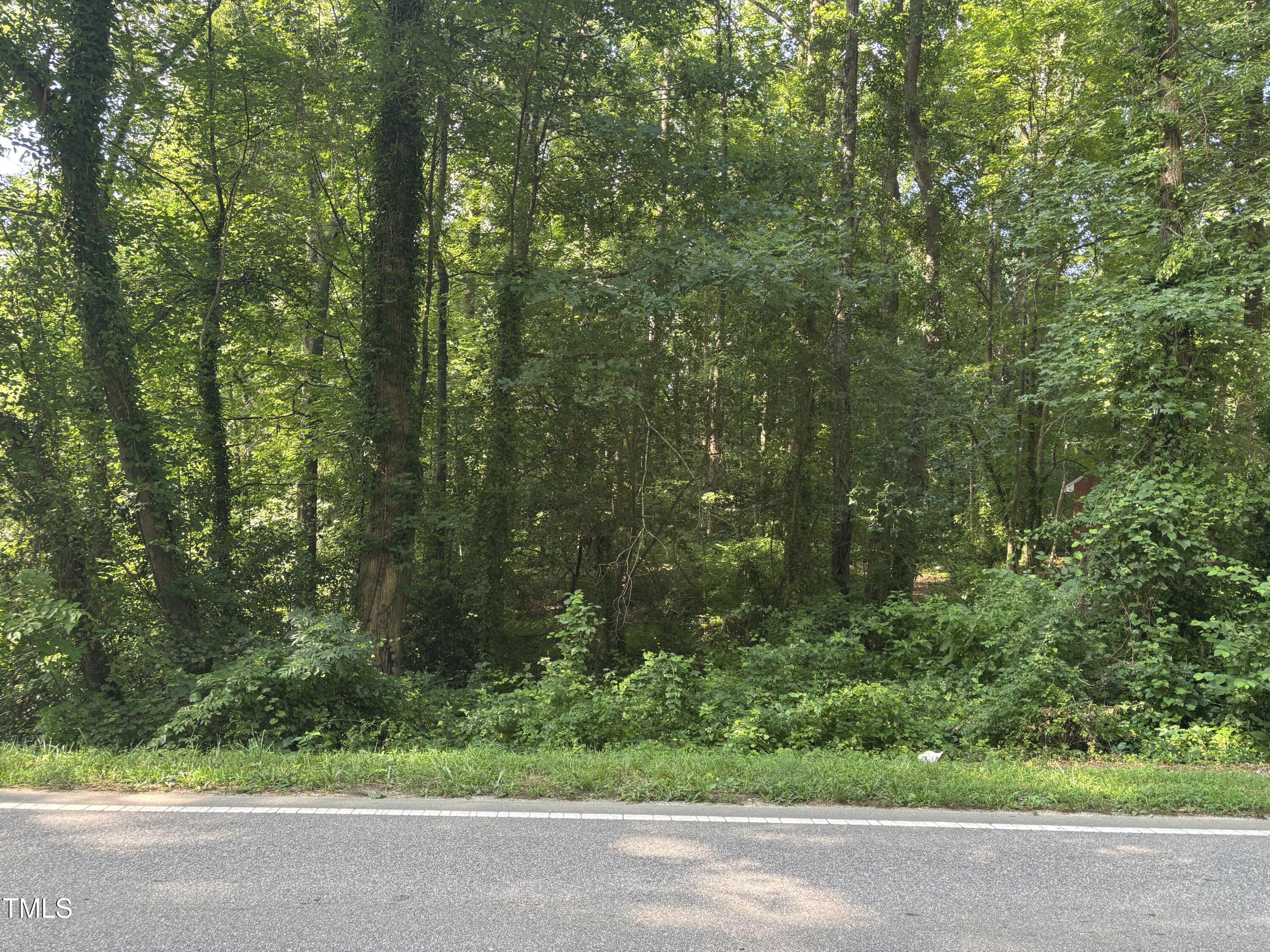 721 Grovemont Road Raleigh, NC 27603 - Photo 2 of 4 a view of a yard with a trees