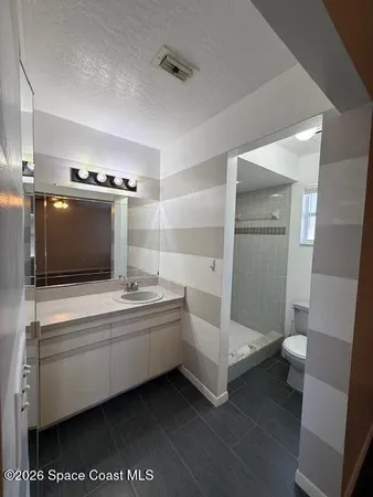 a bathroom with a double vanity sink and mirror