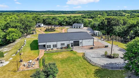 an aerial view of a house with swimming pool garden and patio